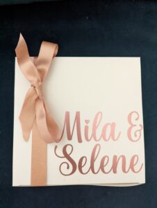 white box with rose gold names and ribbon
